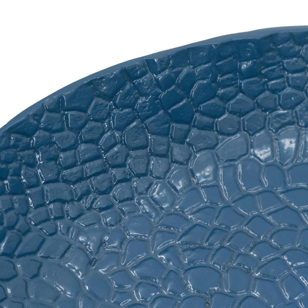 Textured blue surface with a cracked, mosaic-like pattern.