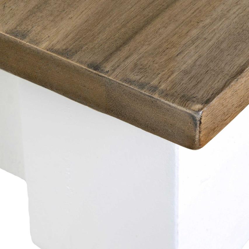 Wooden tabletop with a smooth finish on a white base.