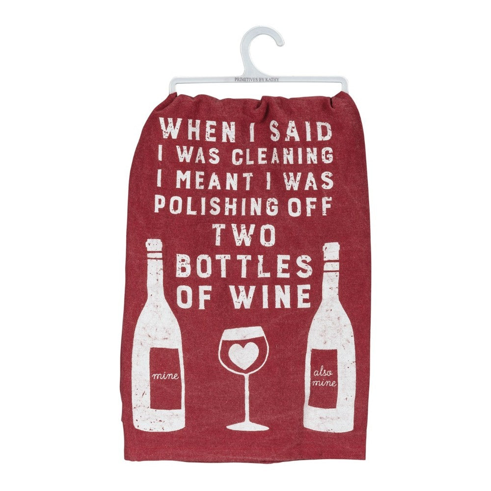 Red towel with humorous wine-themed quote and bottle designs.