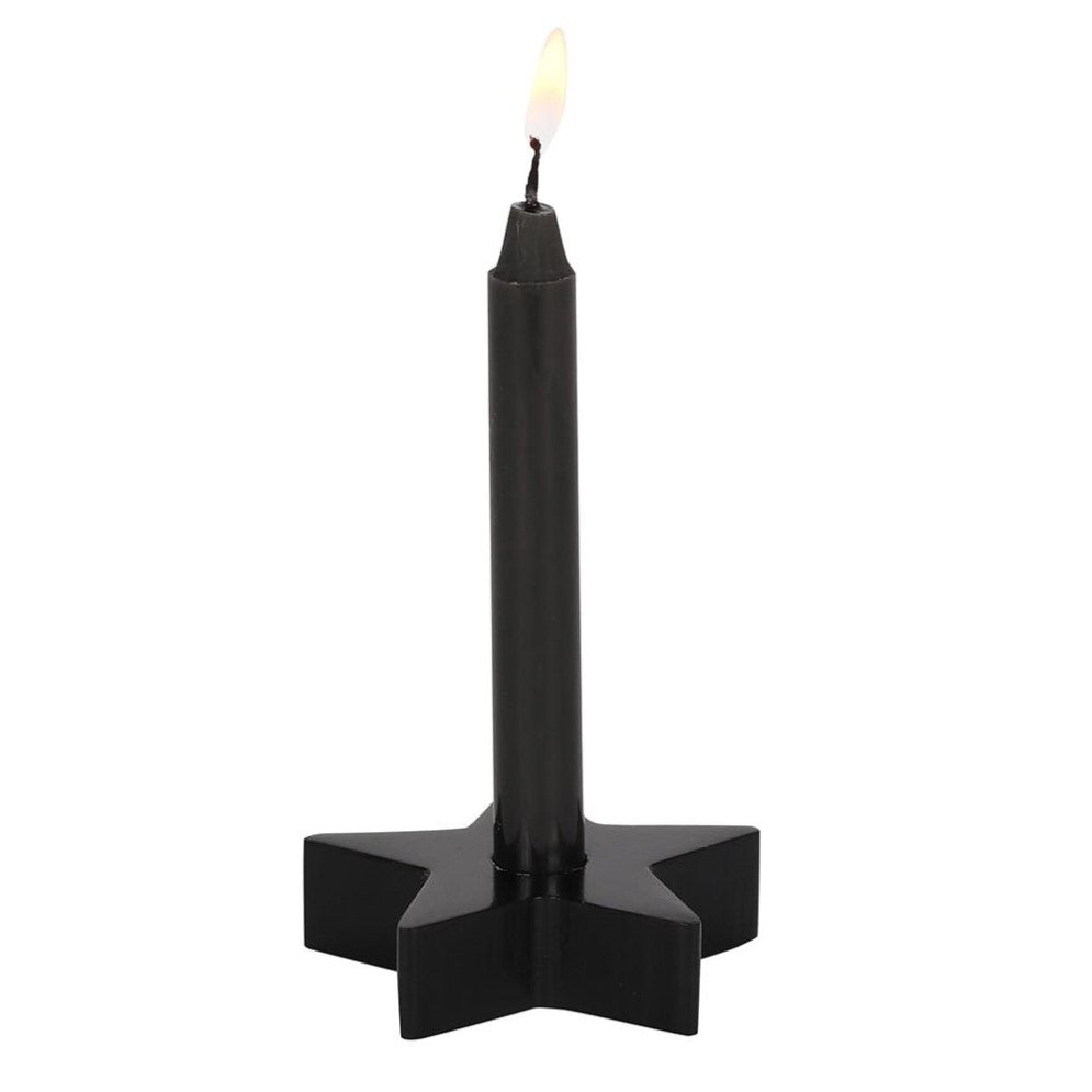 Black candle with flame on star-shaped base.