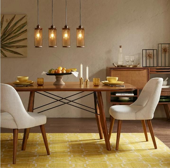Cozy dining room with modern lights and a wooden table set for two.