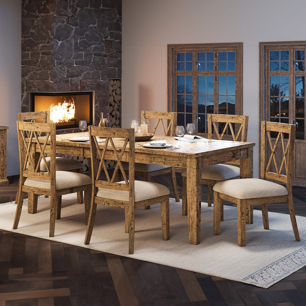 Cozy dining area with wooden furniture and a stone fireplace.