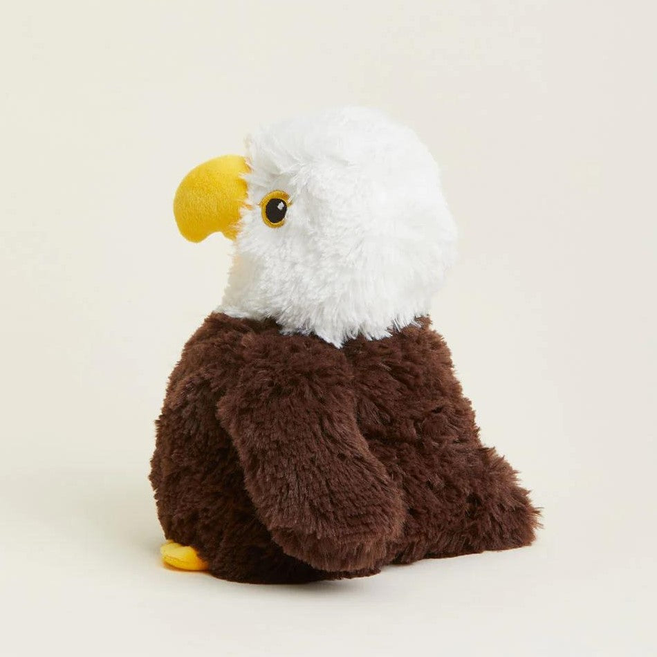Plush toy of a bald eagle with a yellow beak and brown body.