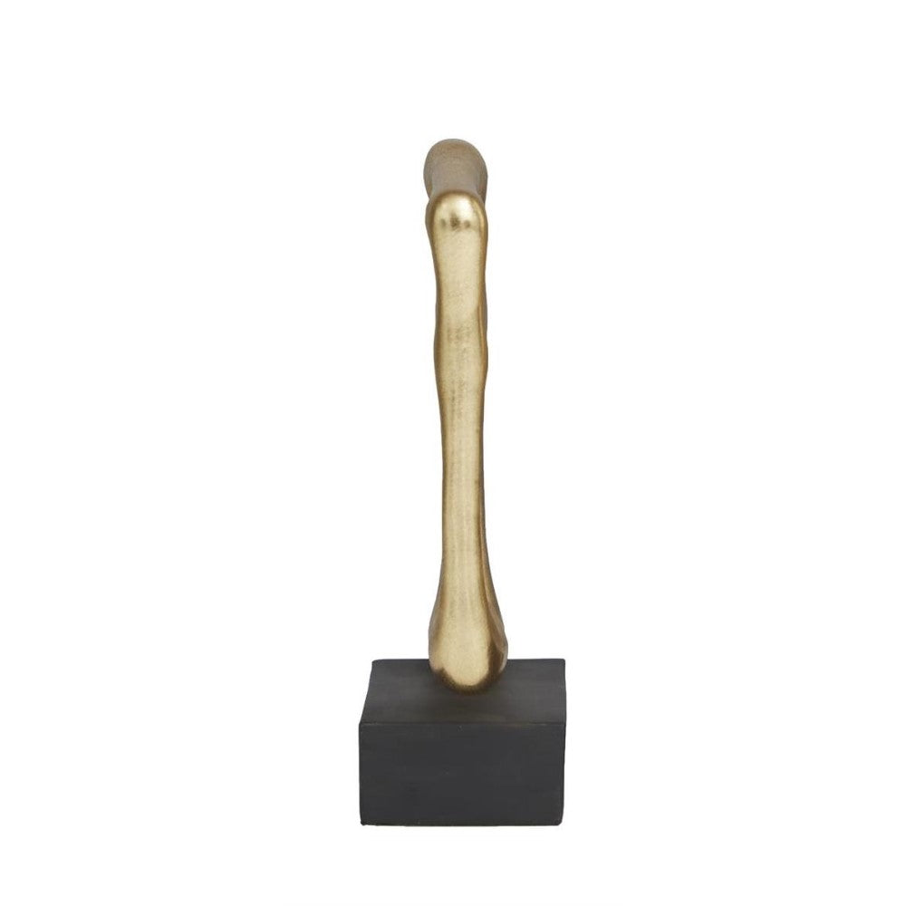 Golden bone sculpture on a black base, standing upright.