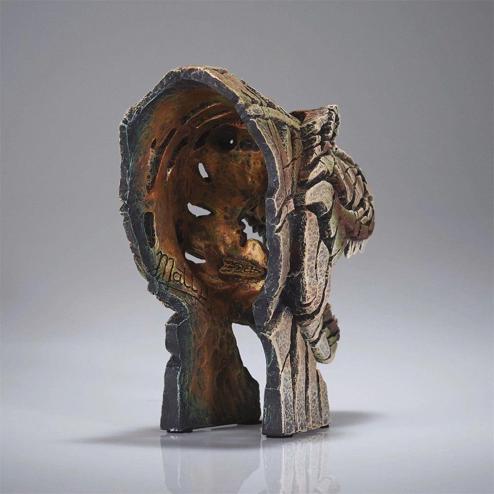 Intricate carved wooden sculpture with an open, hollow center.