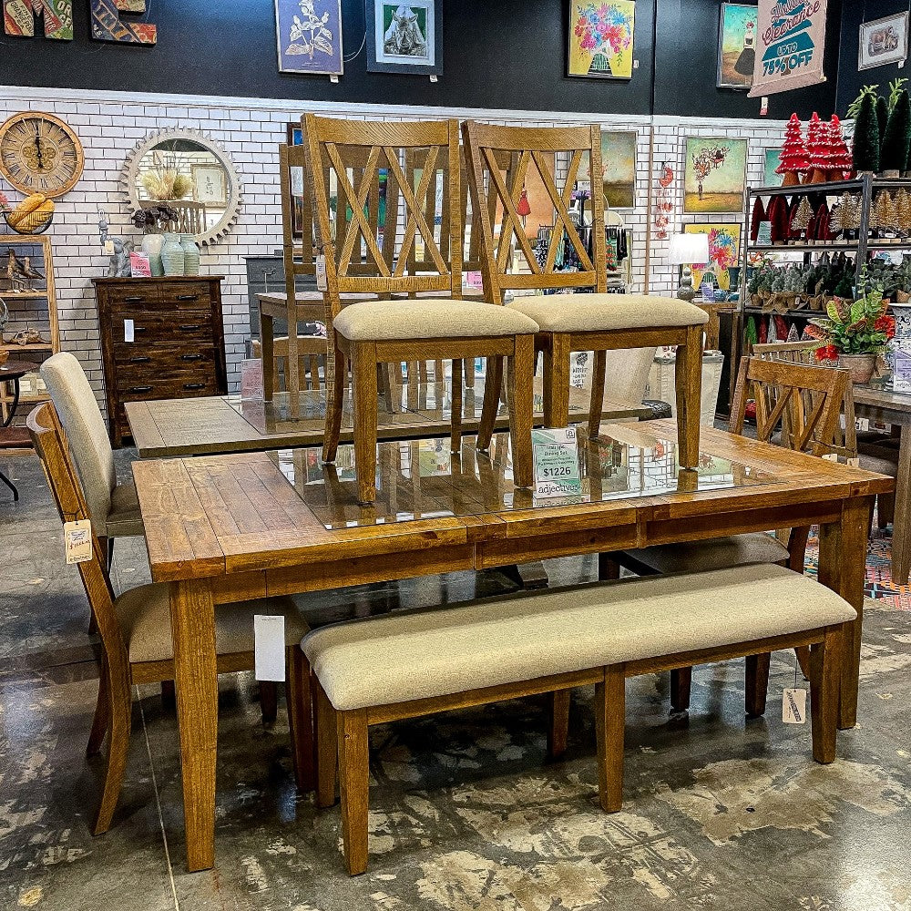 Wooden dining set with chairs and bench in a decor store.
