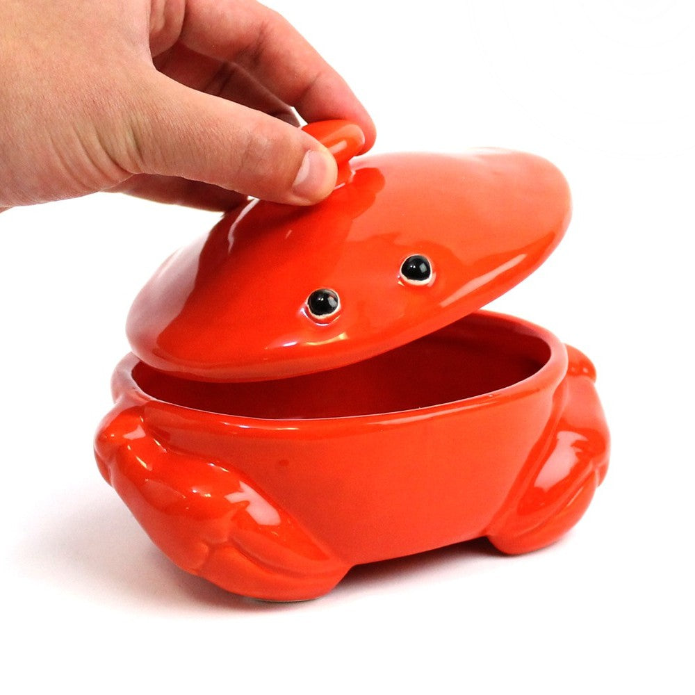 Red crab-shaped ceramic dish with lid being opened.
