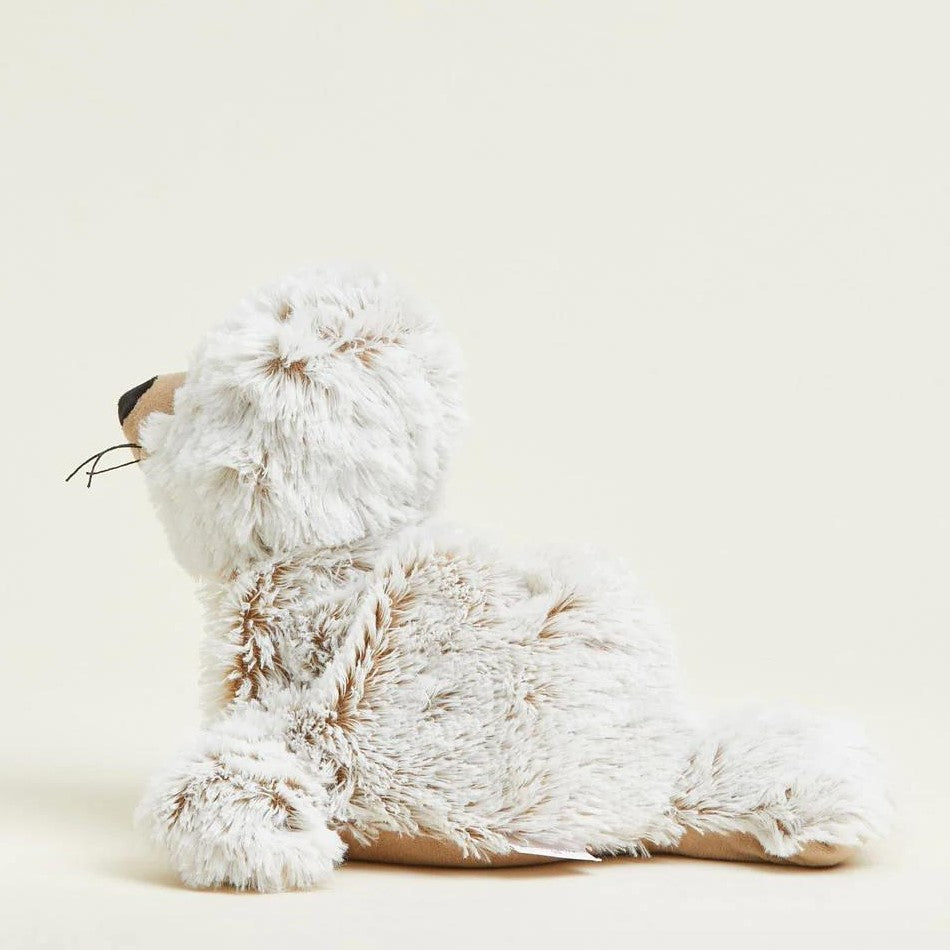 Side view of a fluffy seal plush toy on a light background.