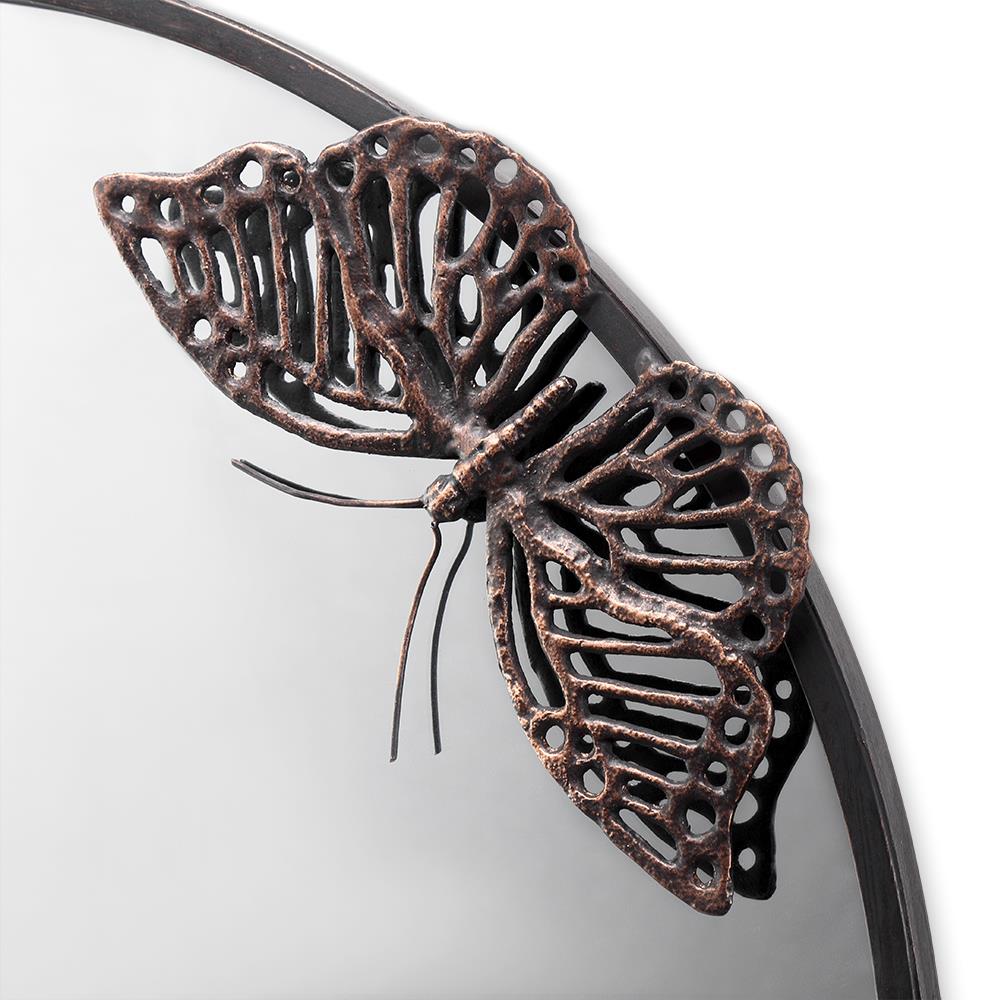 Ornate metal butterfly decor on a reflective surface.