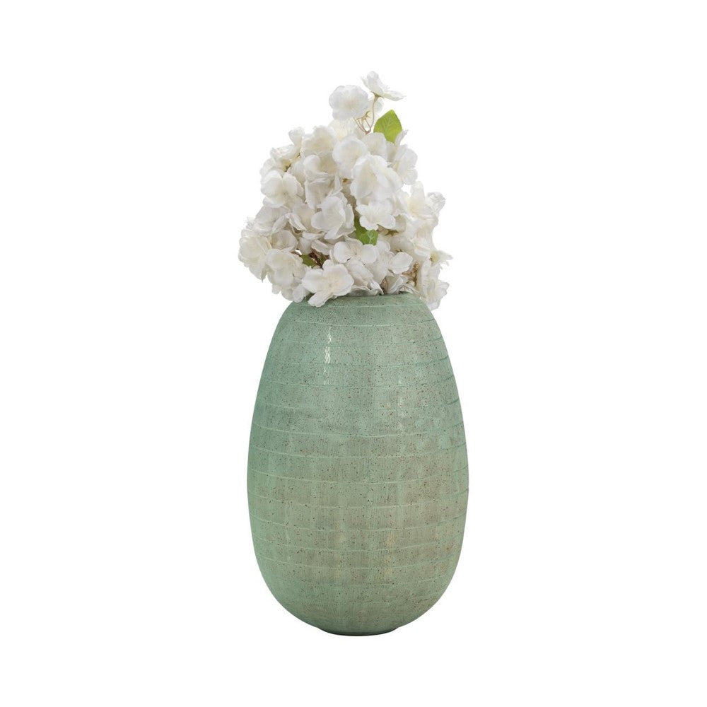 Green vase with white flowers.