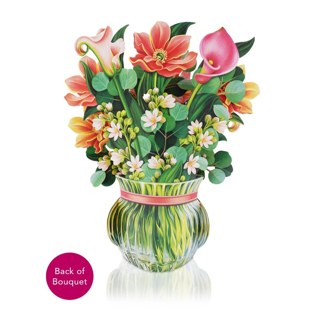 Vibrant bouquet in a vase with various colorful flowers and greenery.