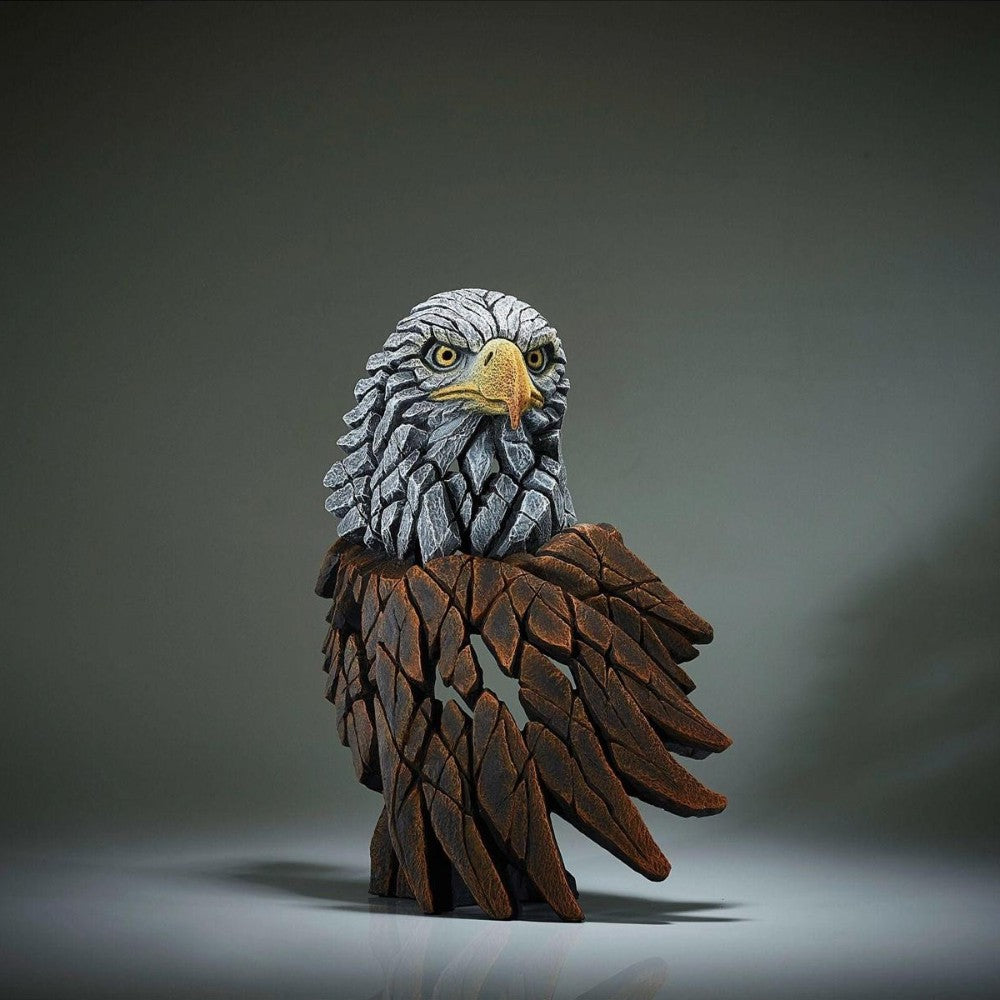 Eagle sculpture with intricate texture and dark background.