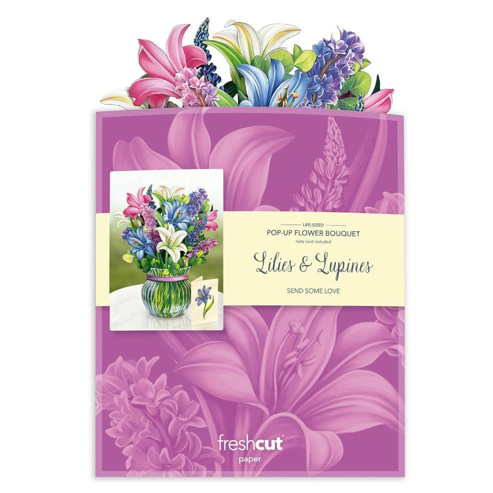Pop-up bouquet display with lilies and lupines on a purple background.