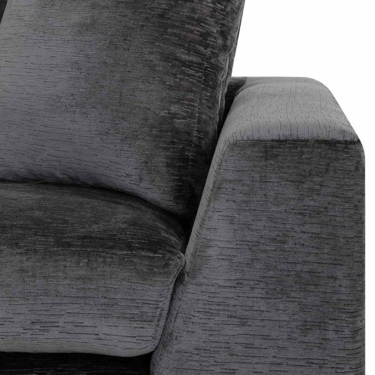 Dark gray textured sofa with plush cushions.