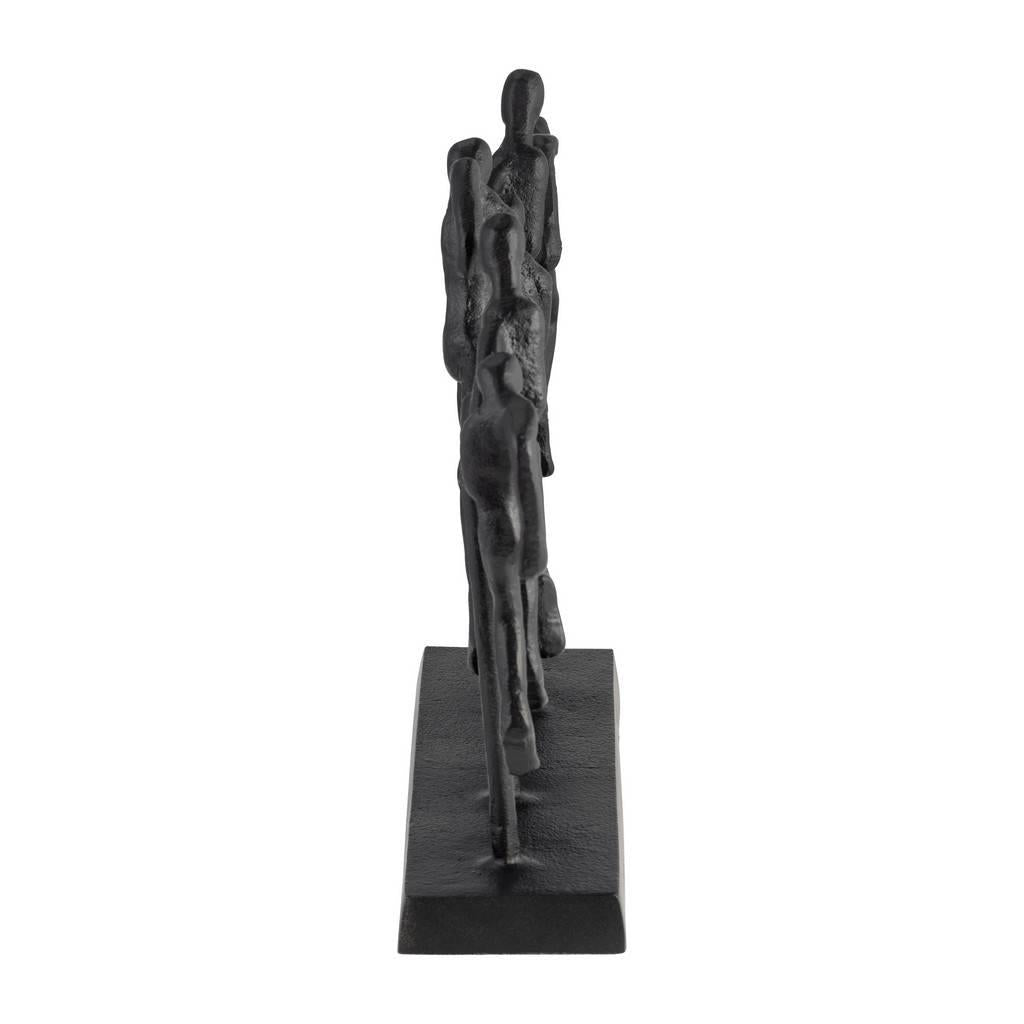 Brass sculpture of six abstract figures walking in line.