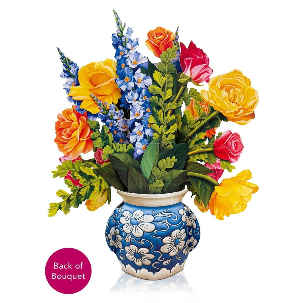 A colorful bouquet in a blue floral vase.