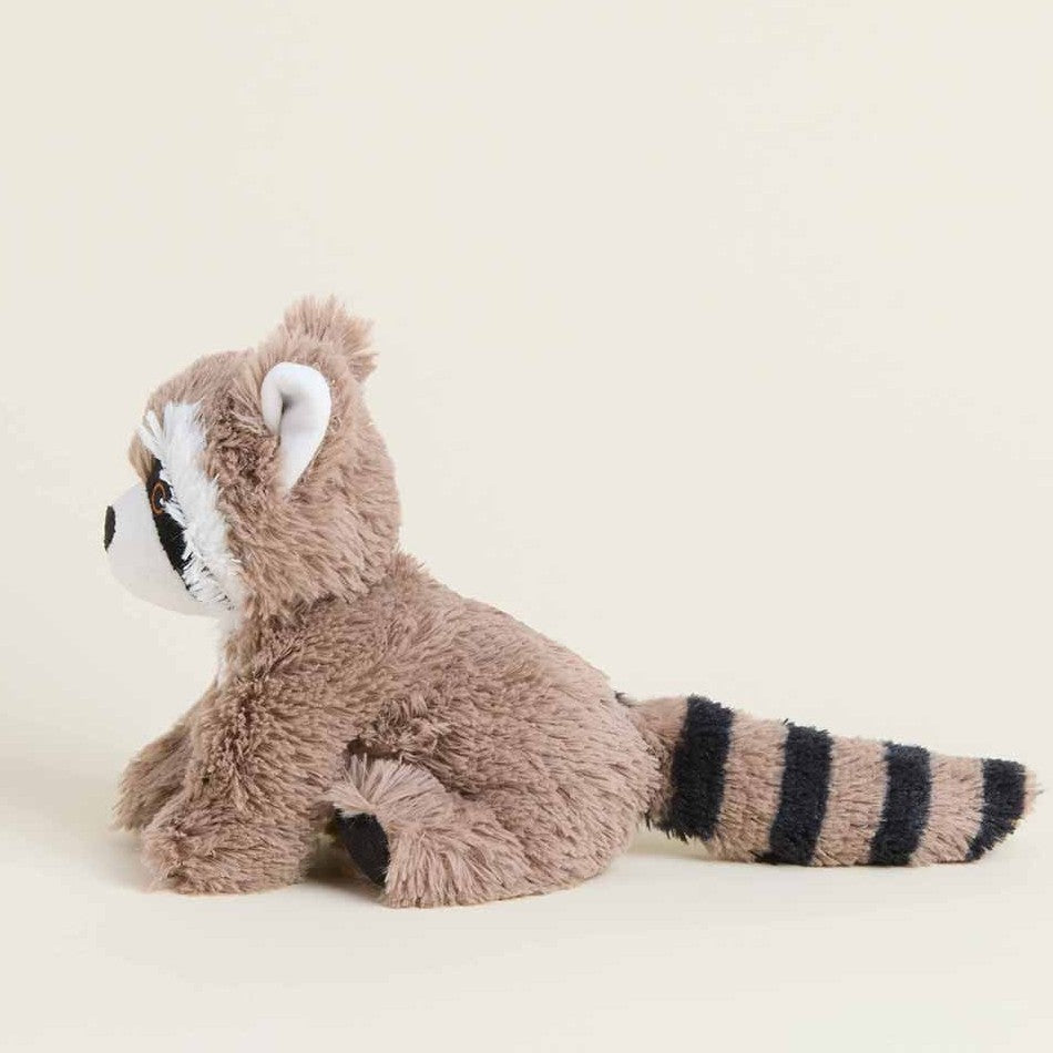 Plush raccoon toy sitting on a light background.