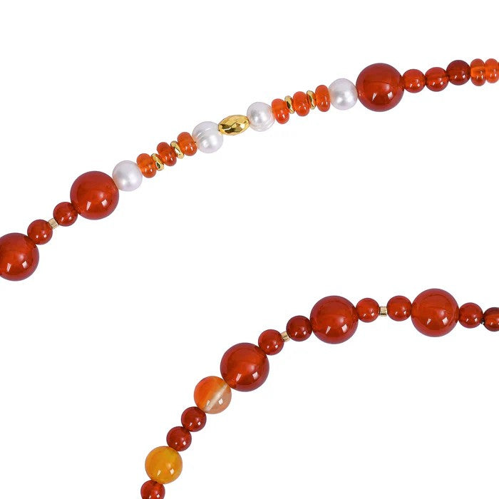 Red and white beaded necklace on white background.
