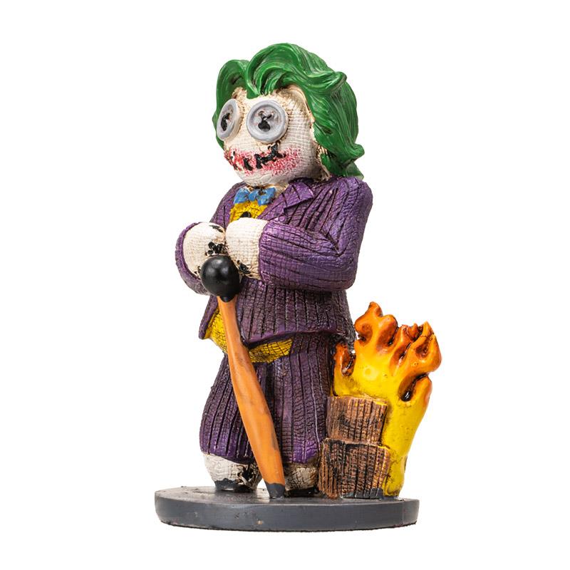 Quirky figurine with green hair, wearing purple suit, beside flames.