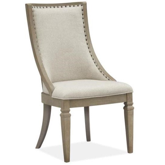 Elegant beige upholstered chair with wooden legs and nailhead trim.