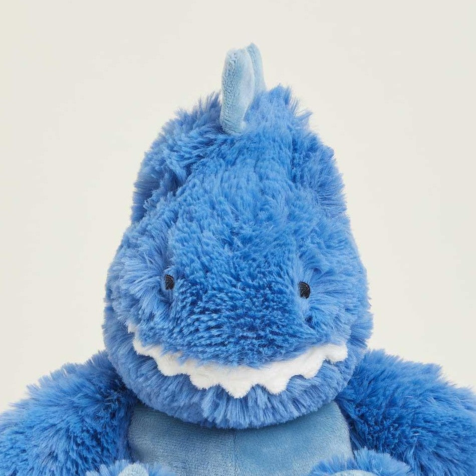 Fluffy blue dinosaur plush with a cute smile.