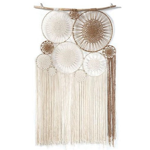 Boho macramé wall hanging with circular patterns and fringe.