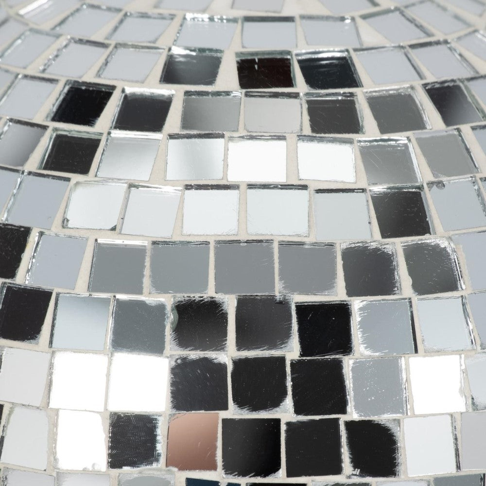 Reflective, tiled surface with square mirror fragments.