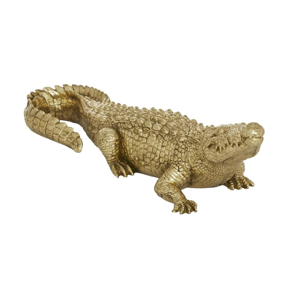 Golden crocodile figurine with a textured surface.