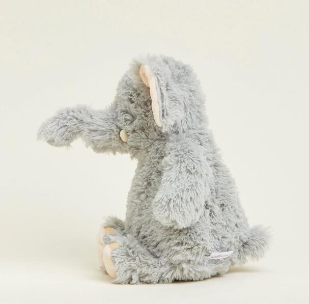 Gray furry elephant plushie sitting in profile.