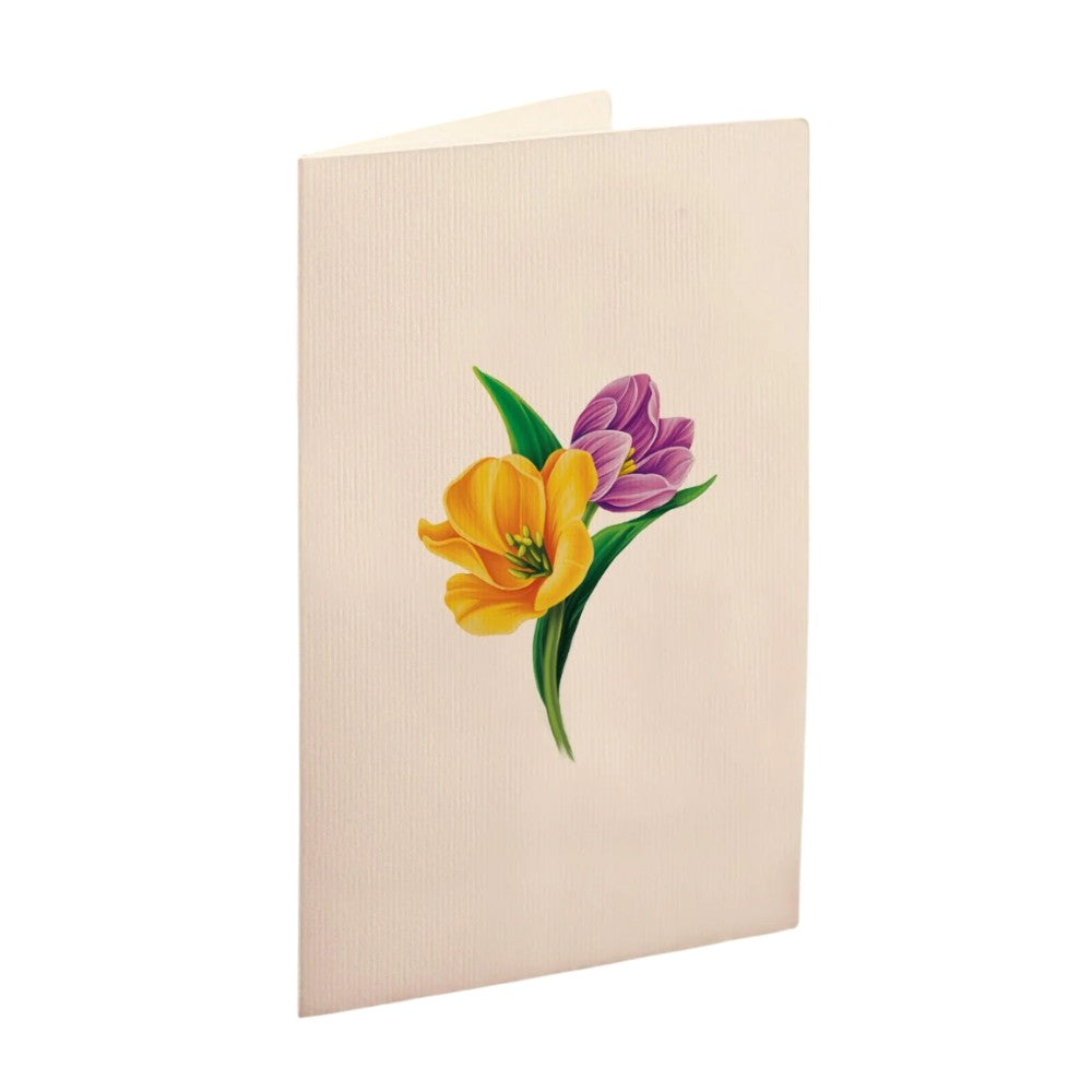 A folded card with yellow and purple flowers on the front.