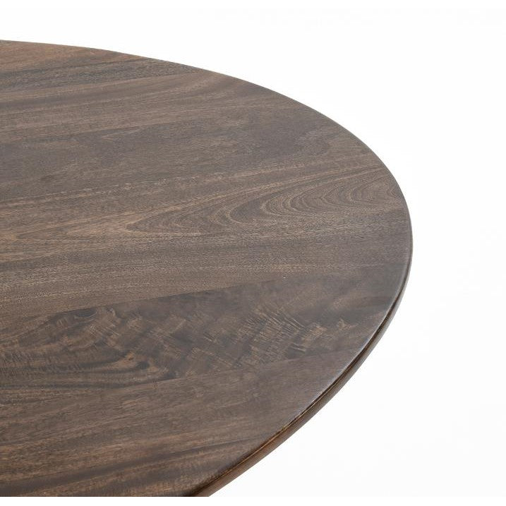 Close-up of a round wooden tabletop with visible grain patterns.