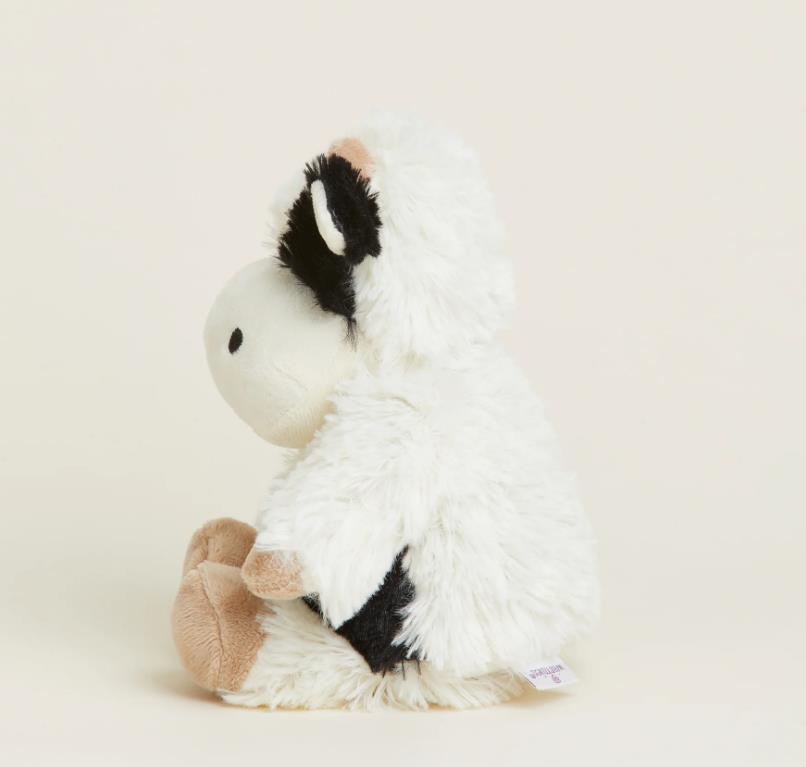 Plushie in profile with white, fluffy fur and sitting pose.