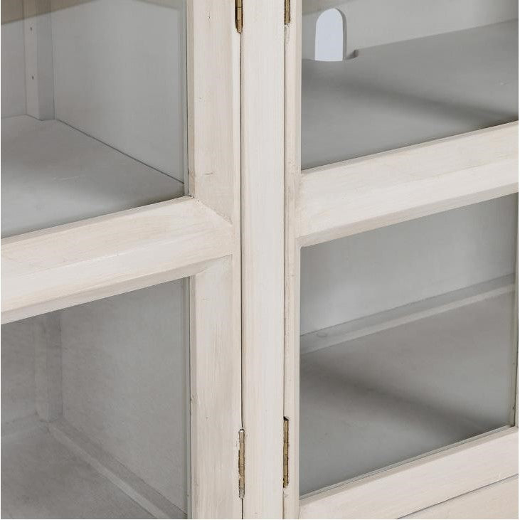 White wooden cabinet with glass doors, viewed partially.