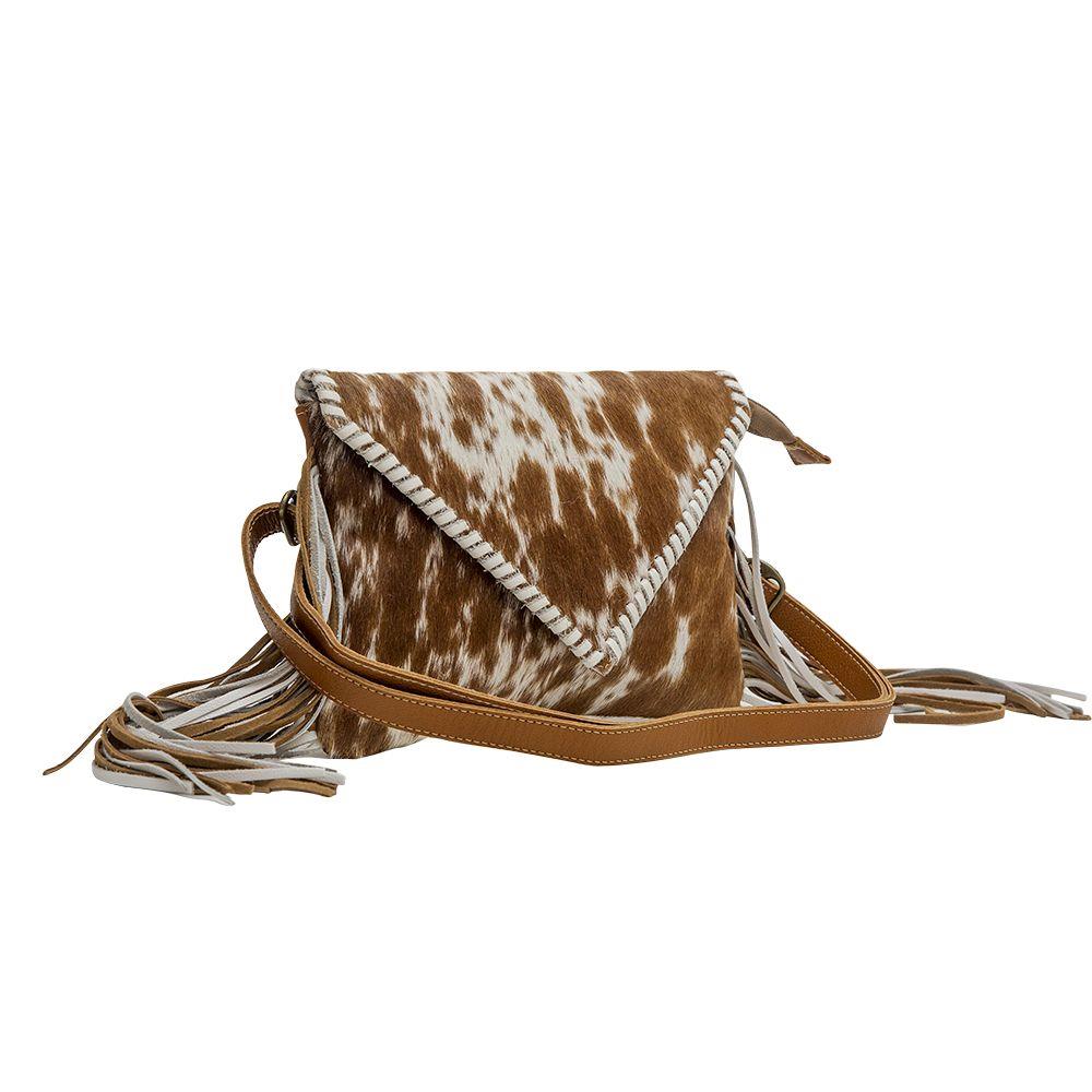 Brown cowhide bag with fringe and leather strap.