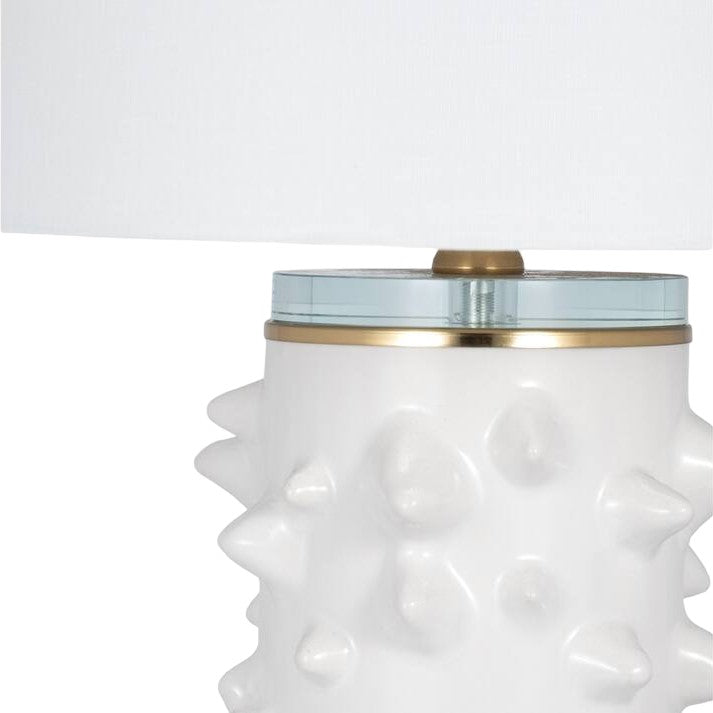White, spiky ceramic lamp base with a glass top and a white shade.