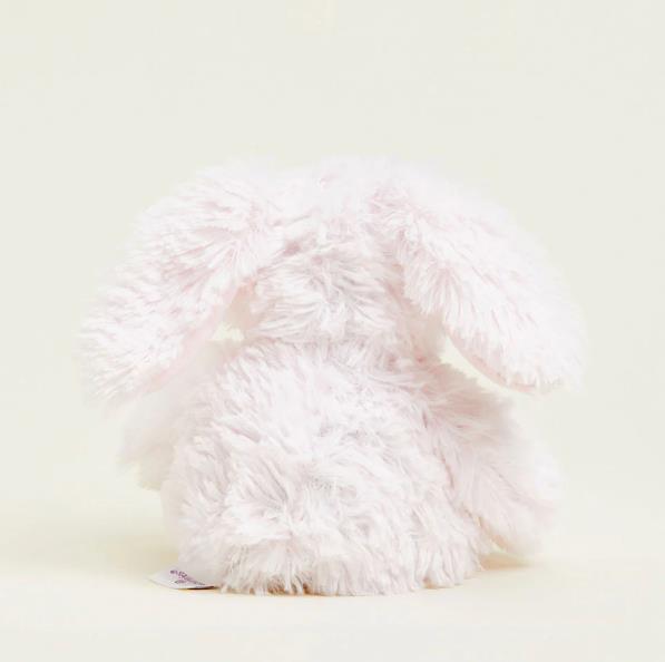 Fluffy white plush bunny facing away.