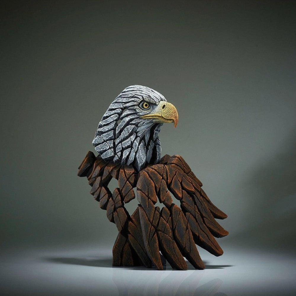 Stone eagle sculpture with detailed feathers.