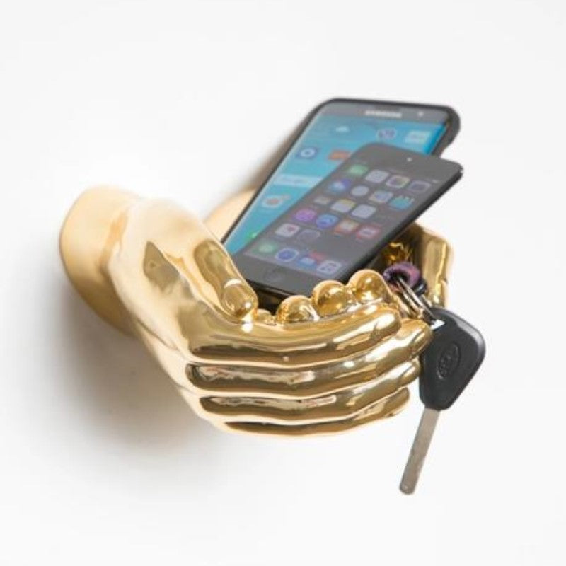 Golden hands holding phones and a key.