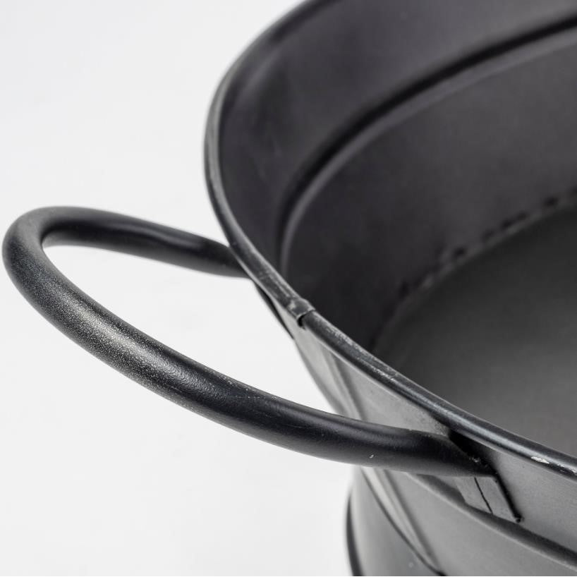 Close-up of a black metal bucket handle.