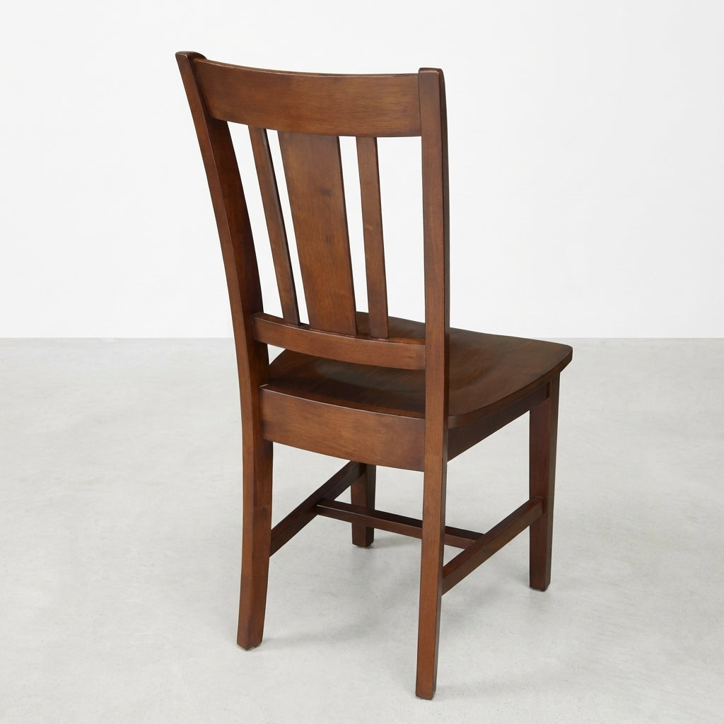 Wooden chair with slatted backrest, viewed from the rear.