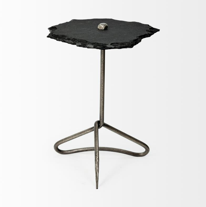Minimalist table with a rough stone top and metal base.