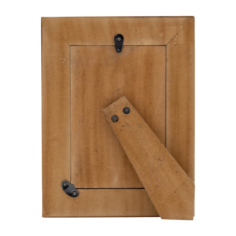 Back of a standing wooden picture frame with metal clasps.