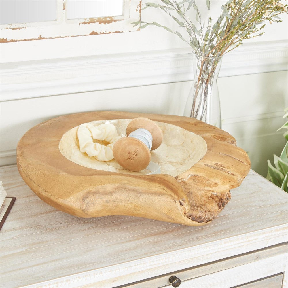 Rustic wooden bowl on a table with thread and a scrunchie.