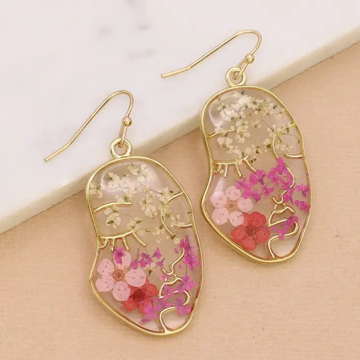 Gold-edged earrings with colorful floral details.
