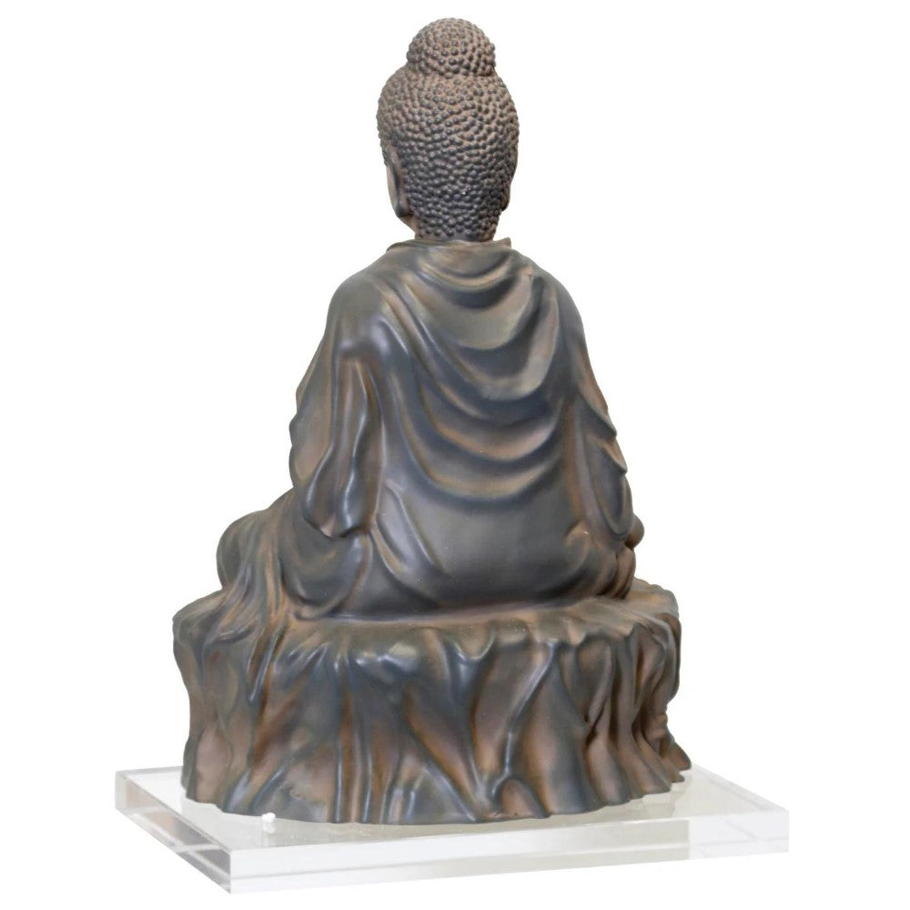 Bronze Buddha statue from the back, detailed robe, and bun hair.