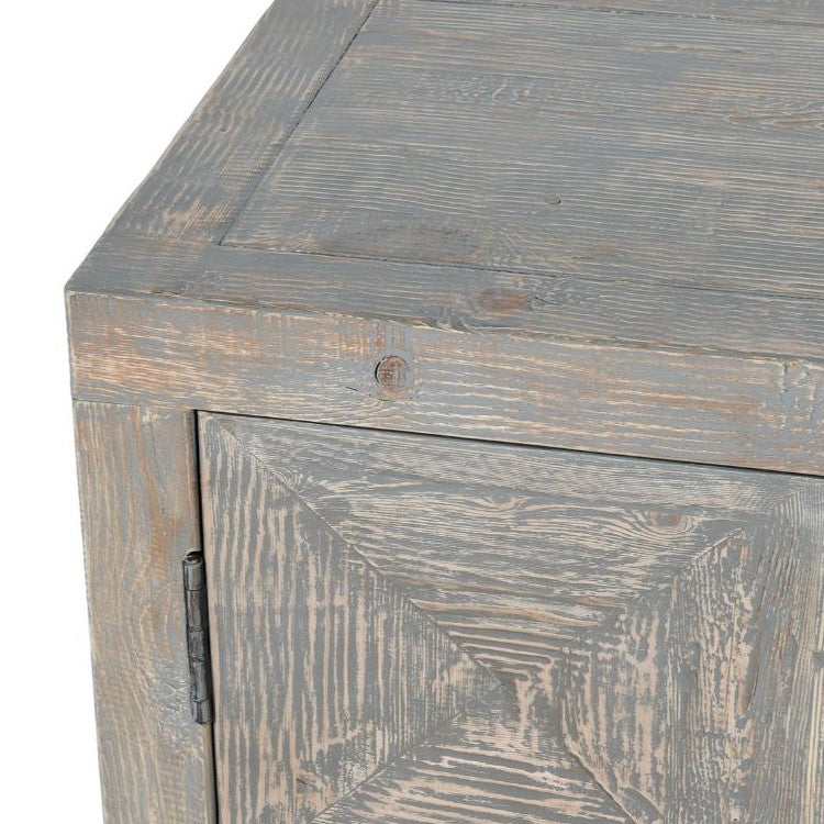 Corner of a weathered wooden cabinet with a rustic, worn finish.