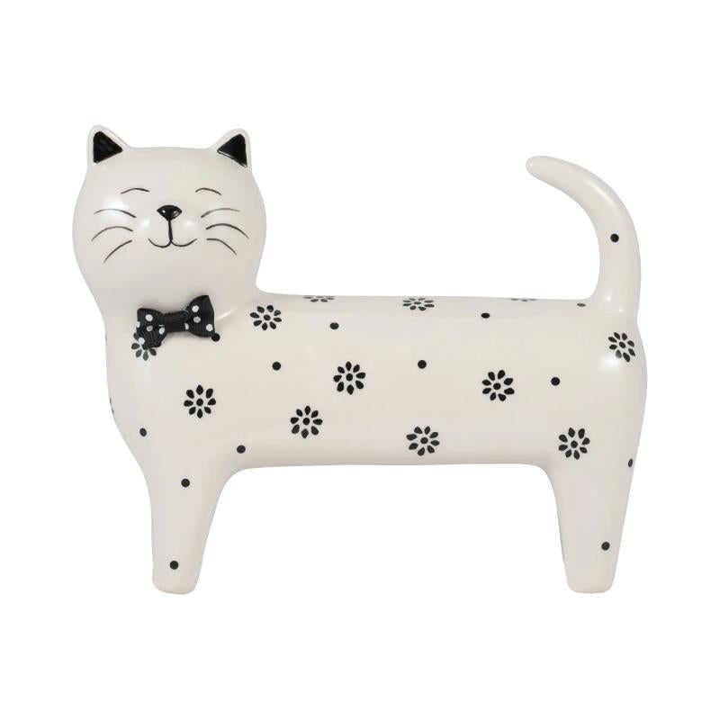 Smiling cat figurine with black bowtie and floral spots.