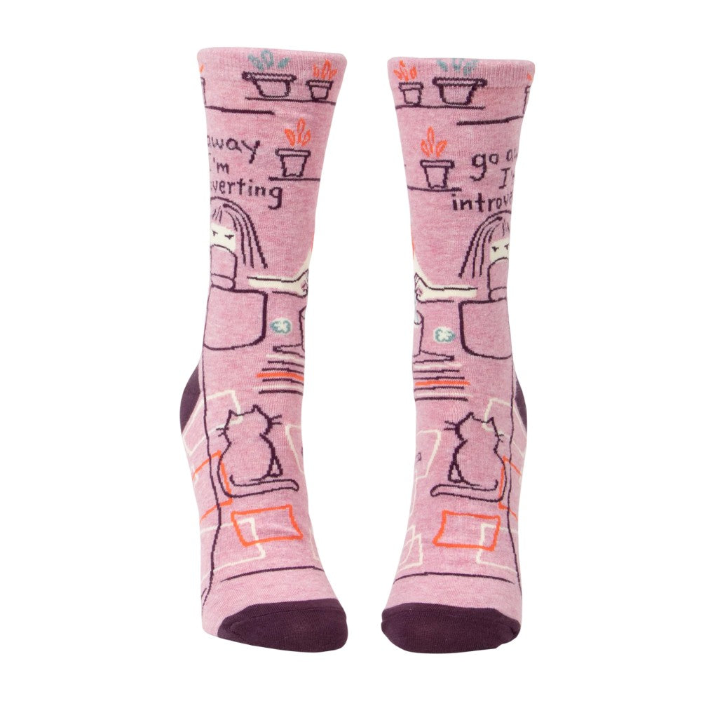 Pink socks with introversion-themed illustrations and text.