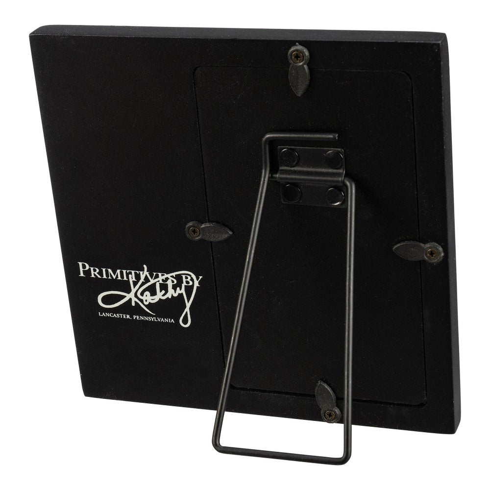 Back of a black tabletop frame with "Primitives by Kathy" logo.