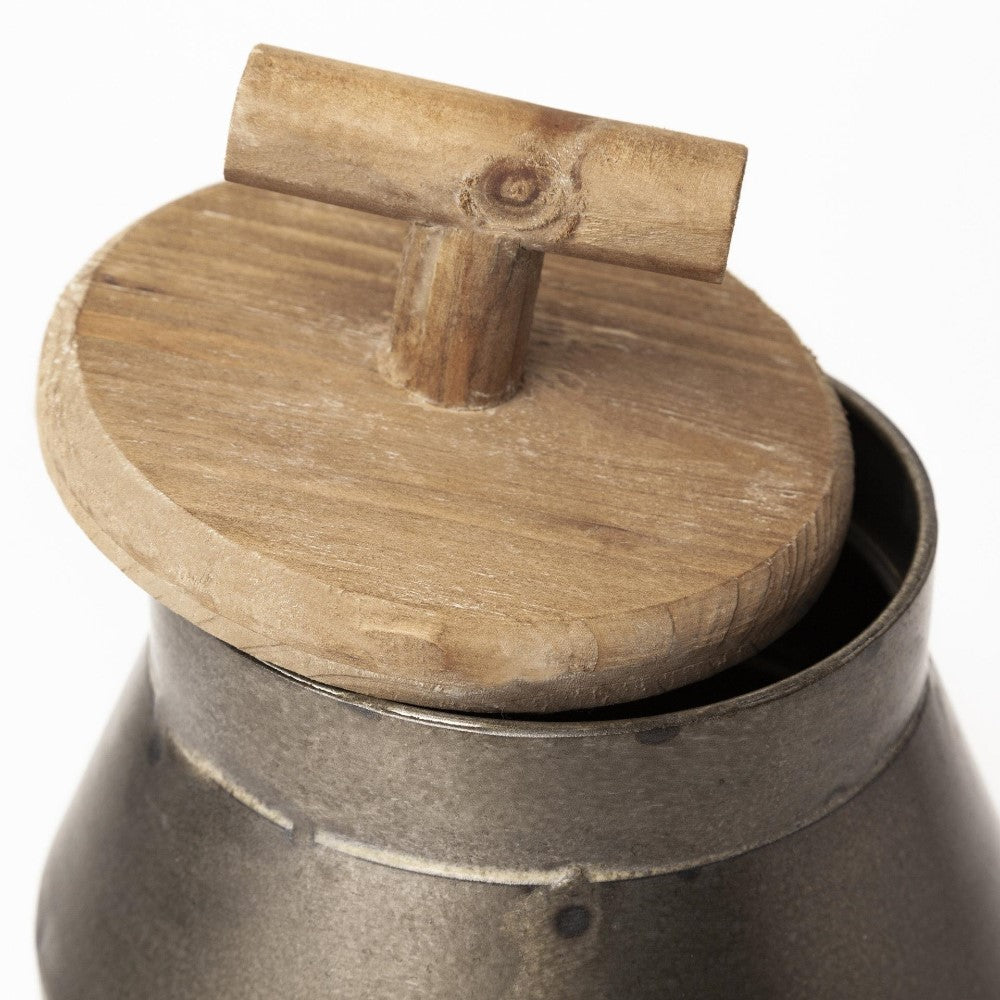 Wooden lid on a metal container, rustic style.